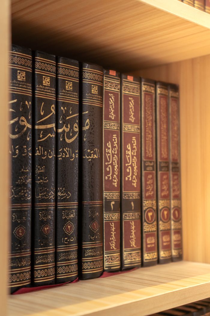 Cozy library scene with traditional Middle Eastern books neatly arranged in soft light.